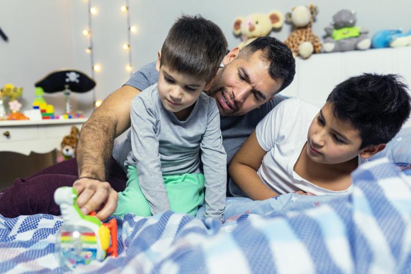 Father Playing with Kids in Bedroom